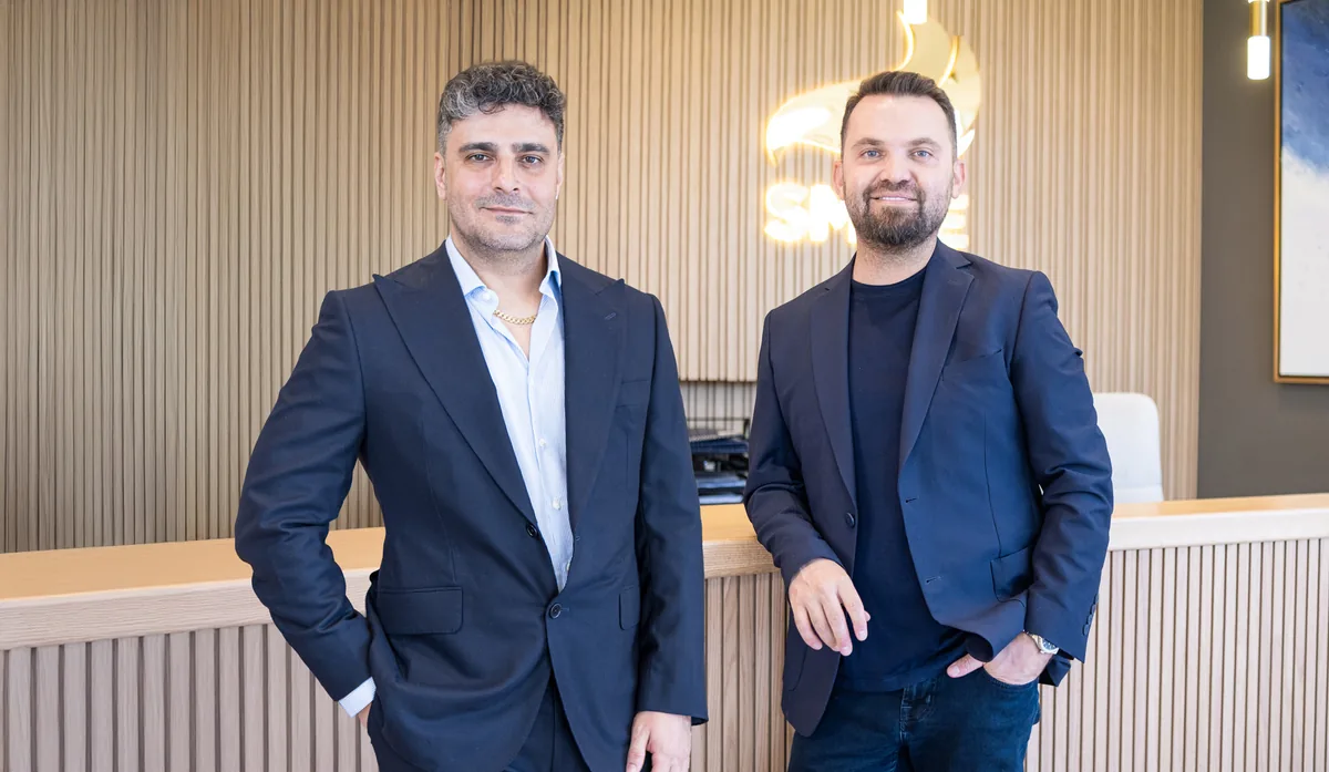 Dr. Gökay Bilgin (left) and Dr. Mehmet Erdoğan (right), the founding surgeons of Smile Hair Clinic, at the clinic reception in Istanbul.